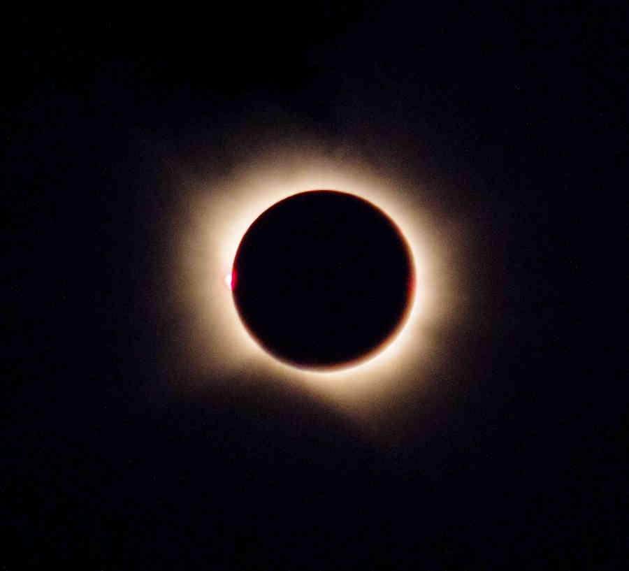 The moon completely covering the sun, with the corona visible.
